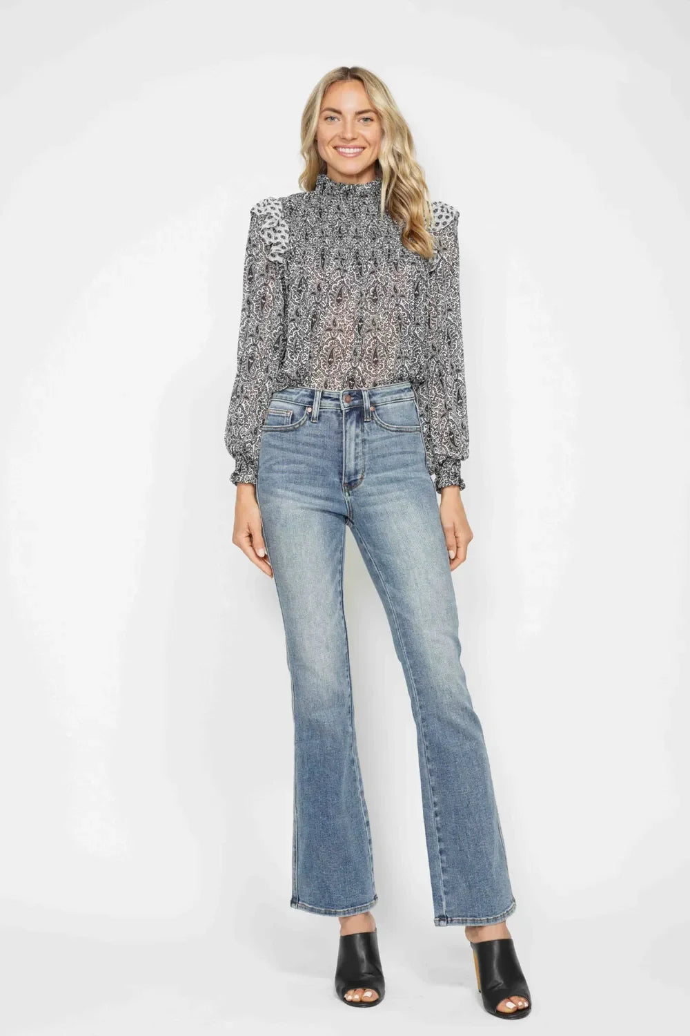 High waist bootcut jeans shown at full length, an example of choosing the right inseam length for your height.