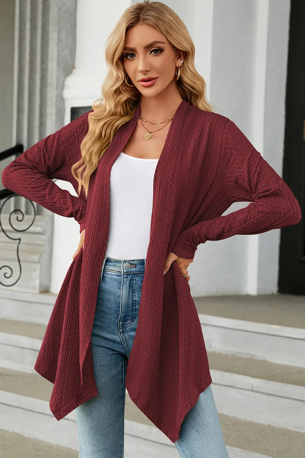 Long open front knit cardigan with a draped front and no closure, a versatile answer to what to wear over a dress in fall.