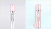 White countertop facial steamer releasing a plume of warm nano mist, illustrating how to use a facial steamer at home