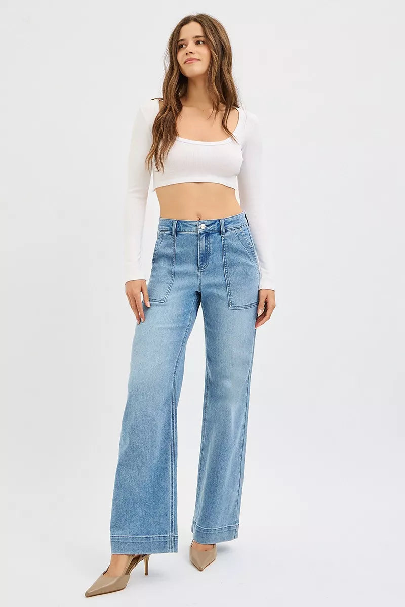 Model wearing medium wash straight leg jeans