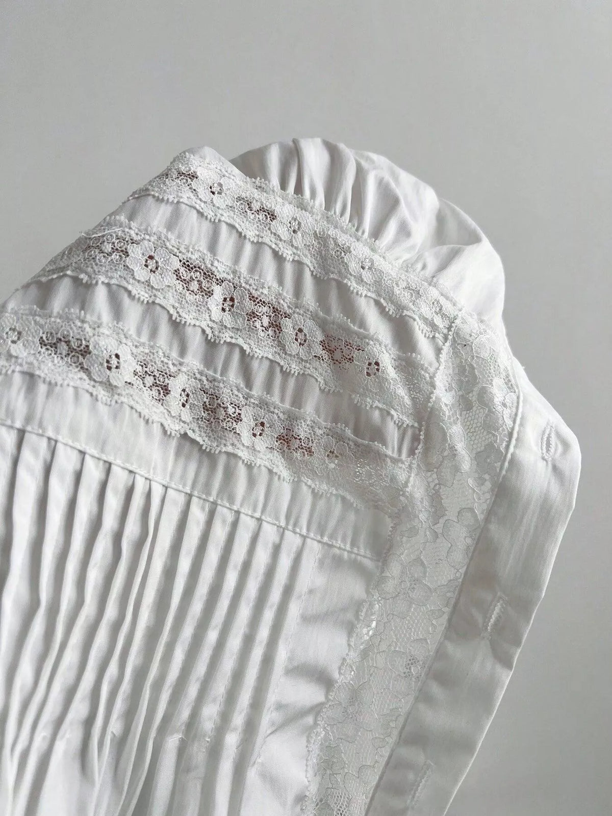 Close detail of the lace and button front