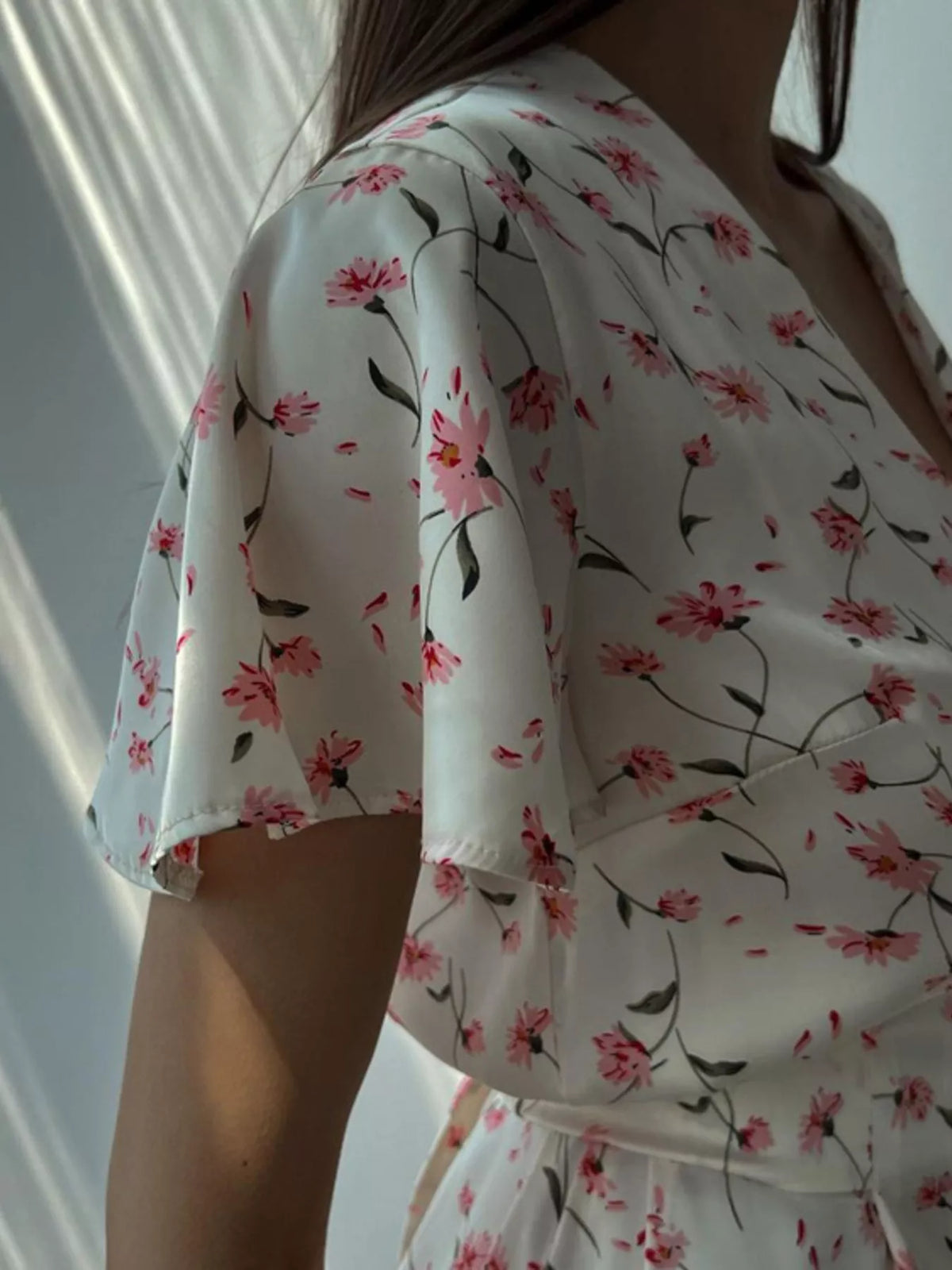 V neckline and button front detail on a dusty pink floral dress