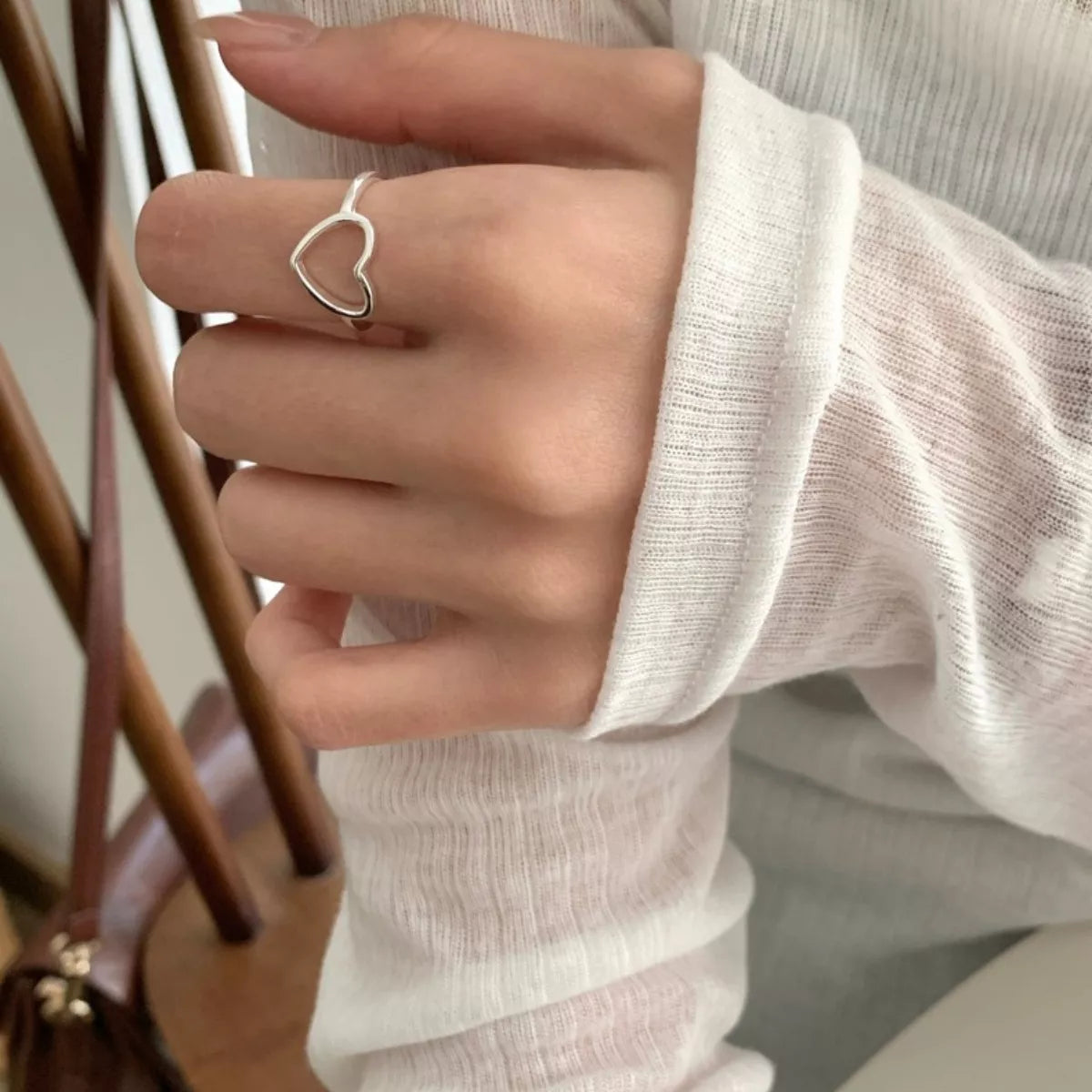 Sterling silver heart ring worn on a model hand