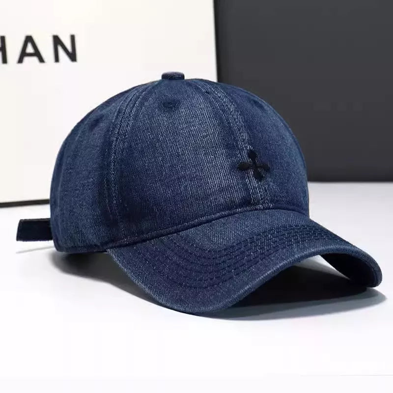 Close up of the embroidered detail on a denim baseball cap