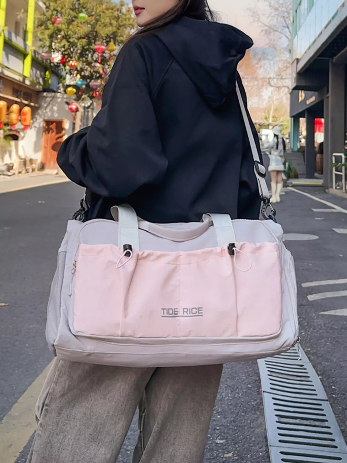 Drawstring closure on pink duffel bag