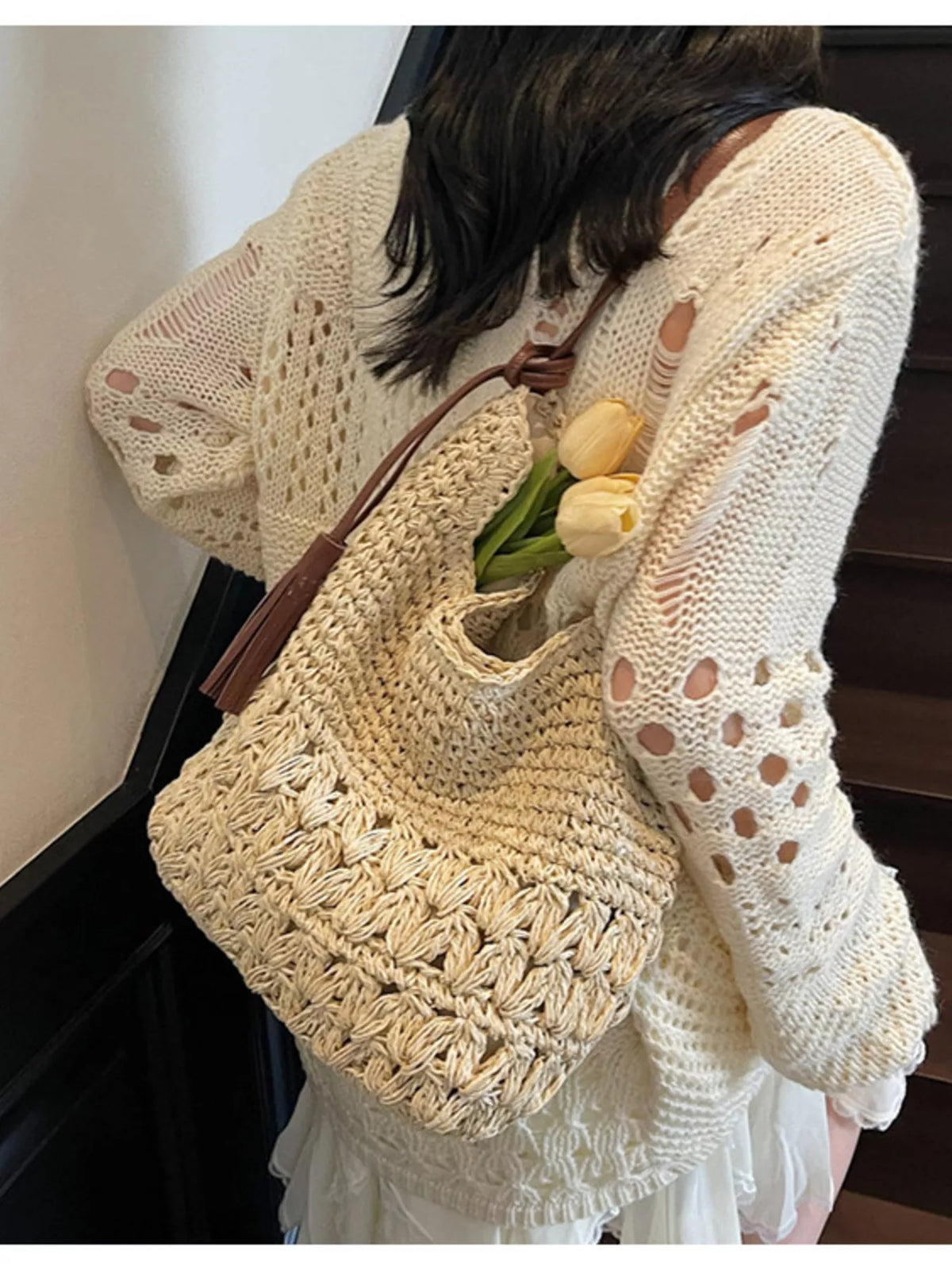 Cream straw shoulder bag styled for the beach