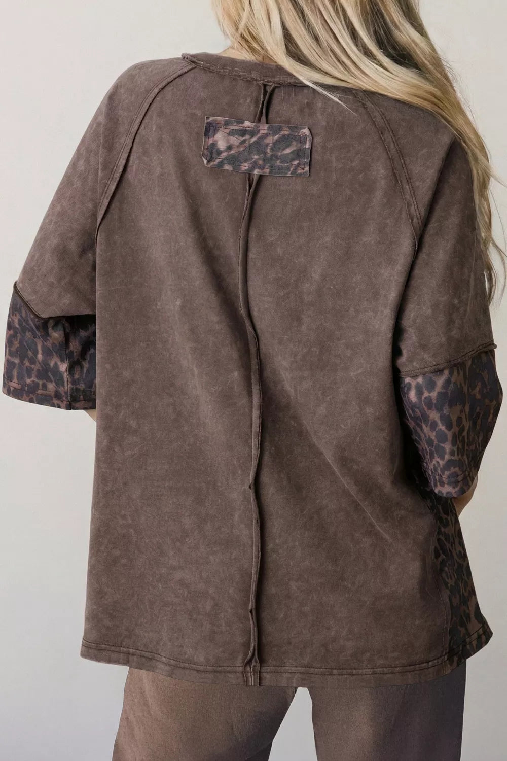 Close view of the leopard star patch detail on the brown tee
