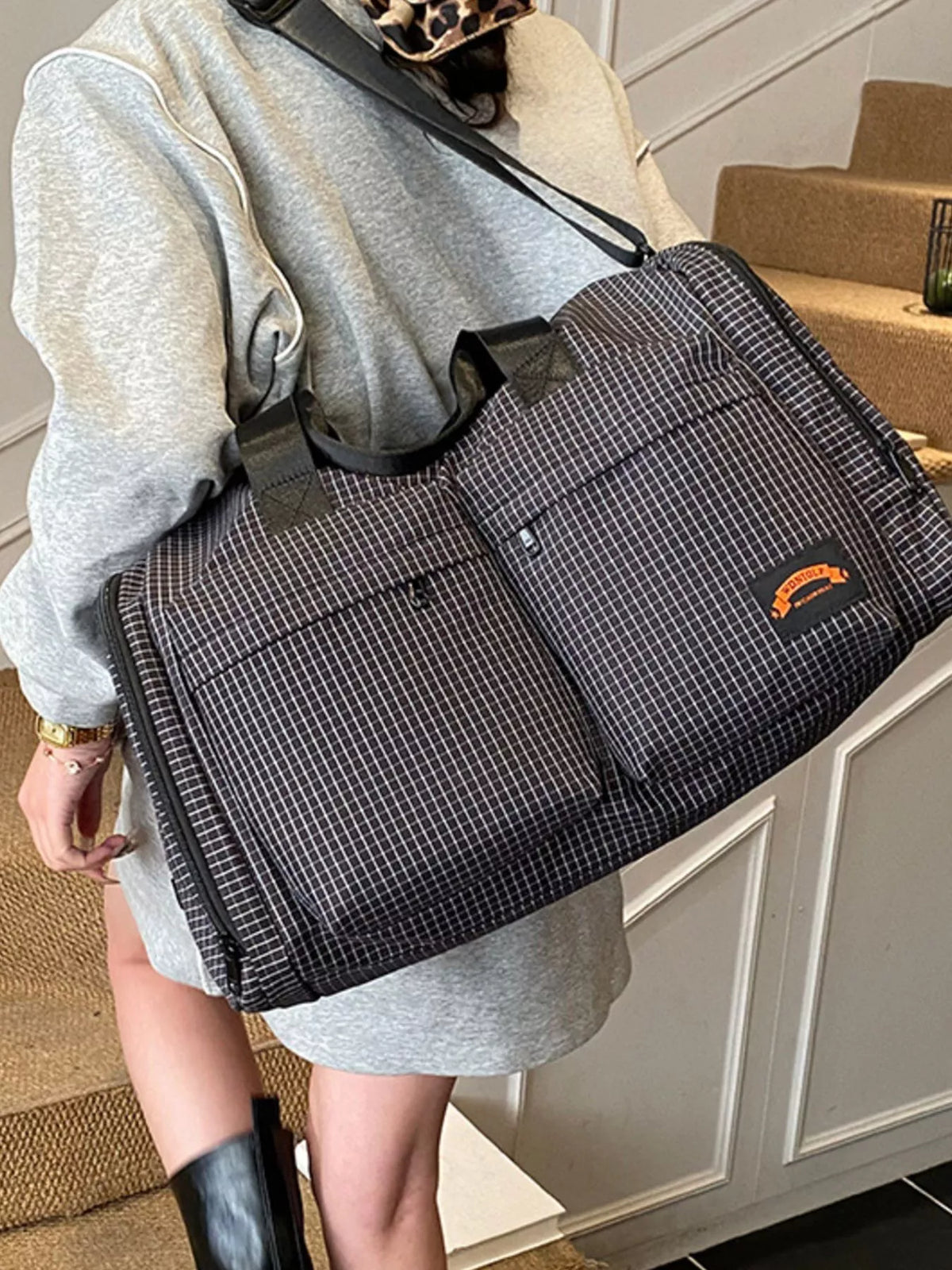 Black plaid duffel bag end pocket view