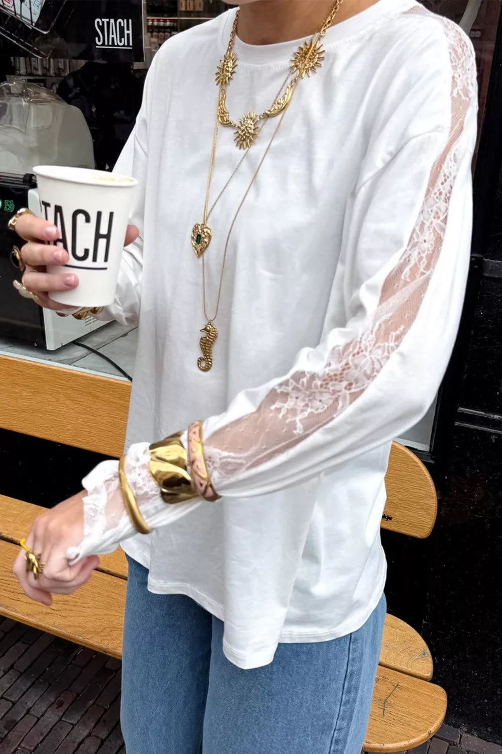 Side view of the white long sleeve lace top