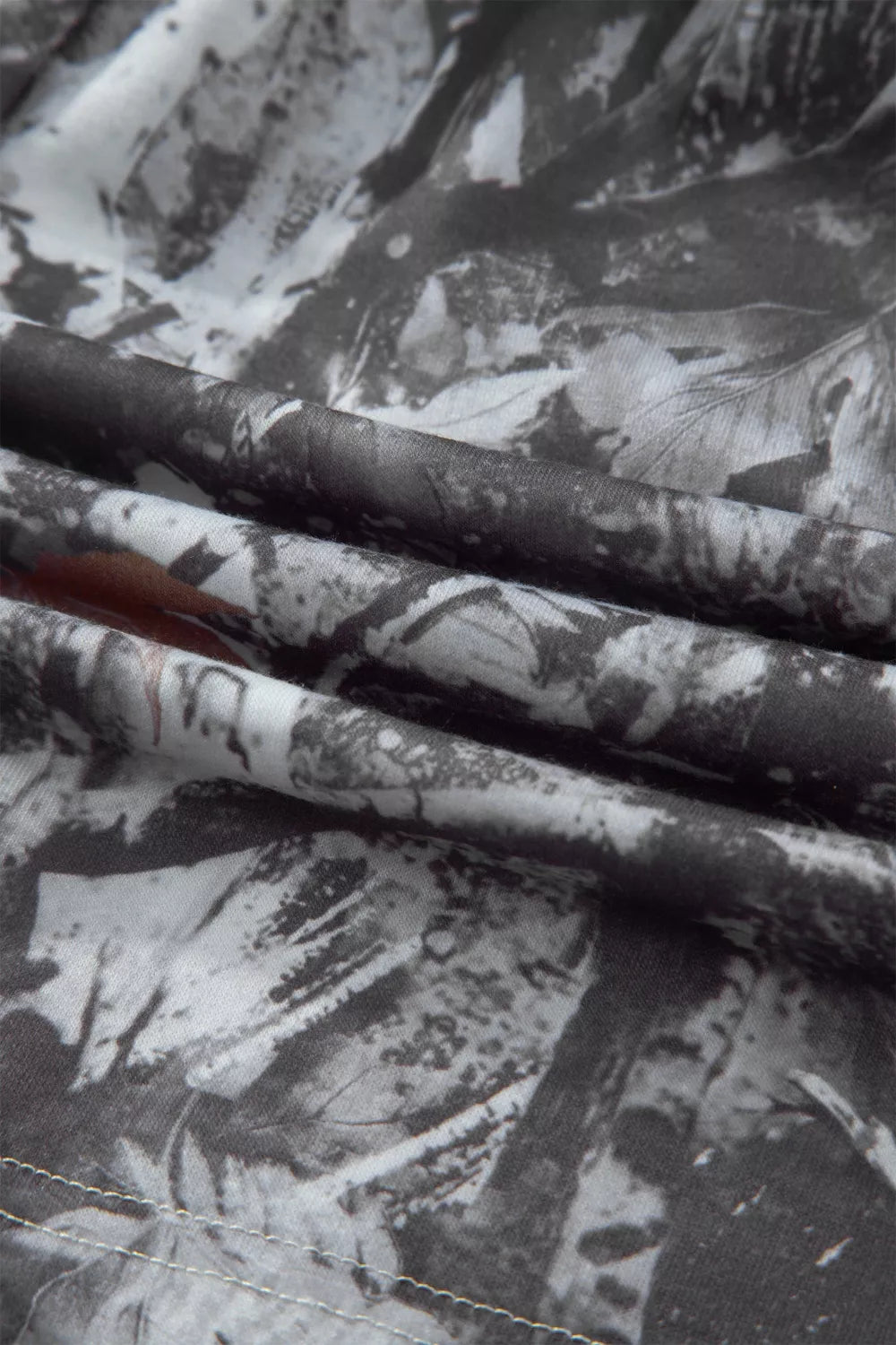 Grey abstract maple leaf print drawstring shorts close up view