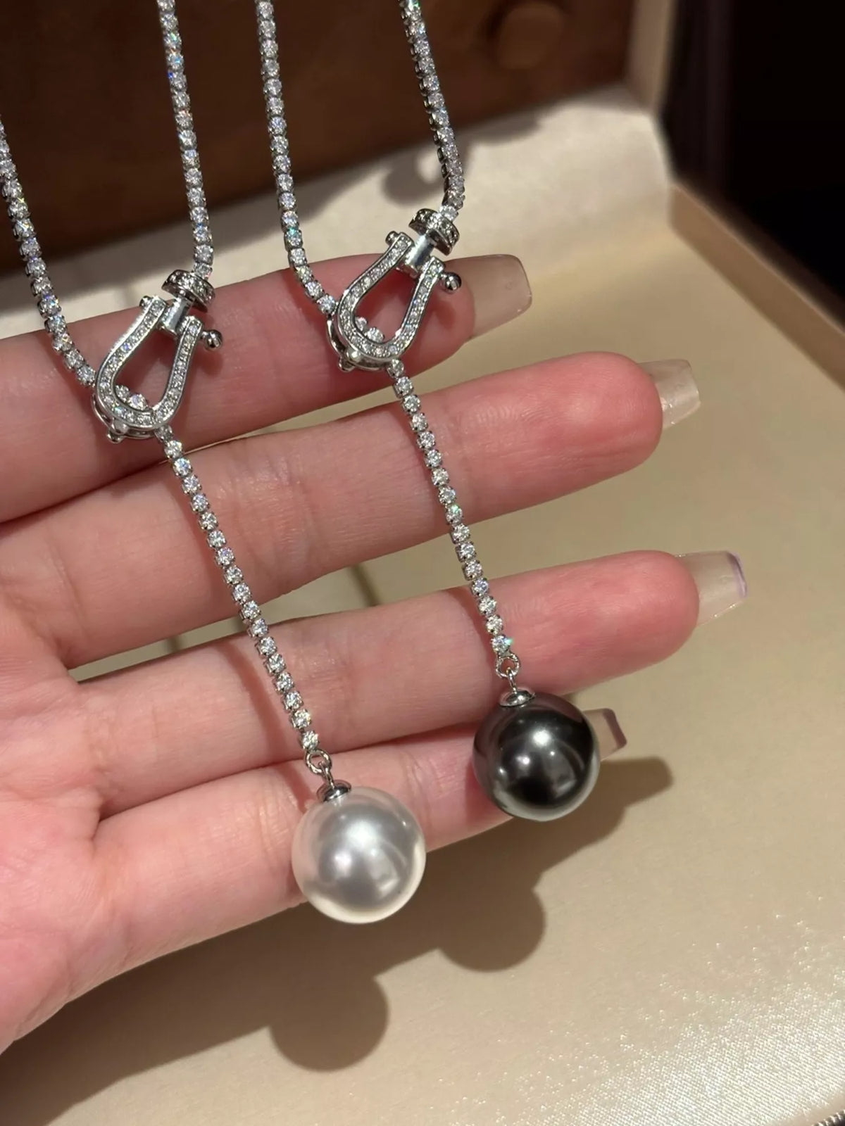 Pearl drop Y necklace with zircon accents, close up of the detail