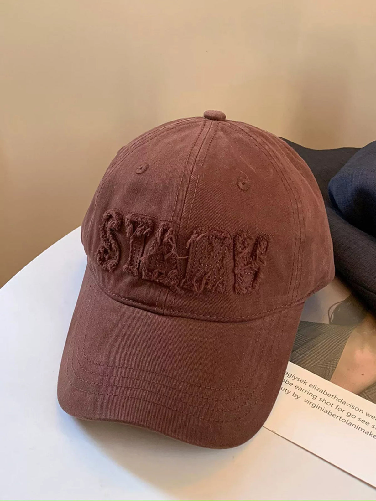 Grey baseball cap shown from the back