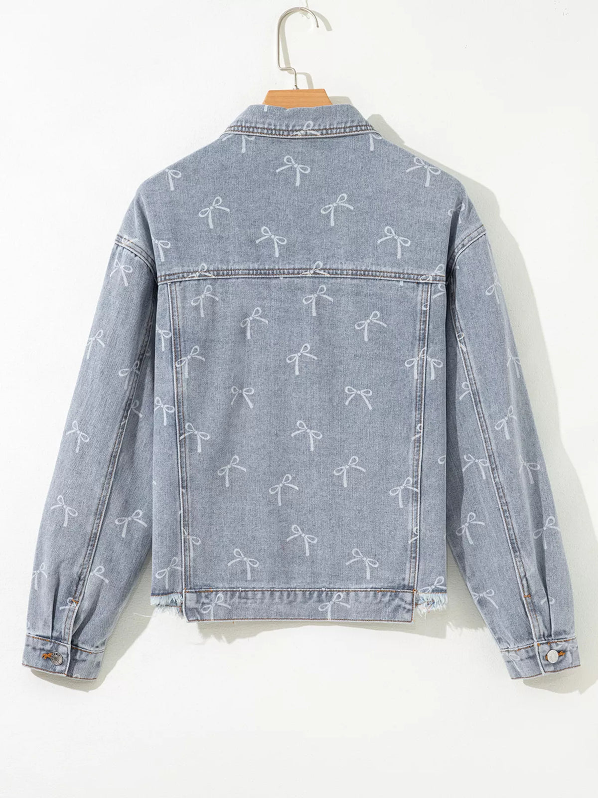 Bow Print Raw Hem Denim Jacket in Light Wash close up