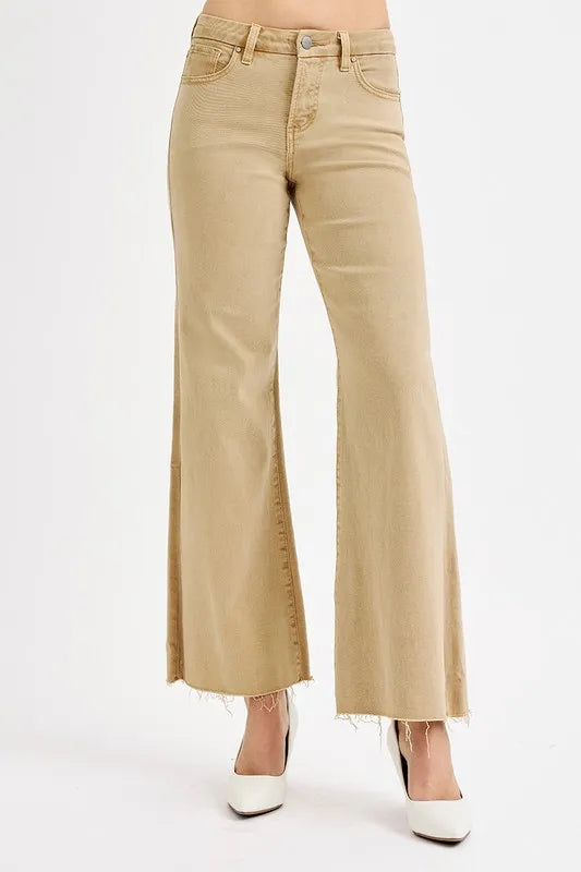 Frayed raw hem detail on tan jeans