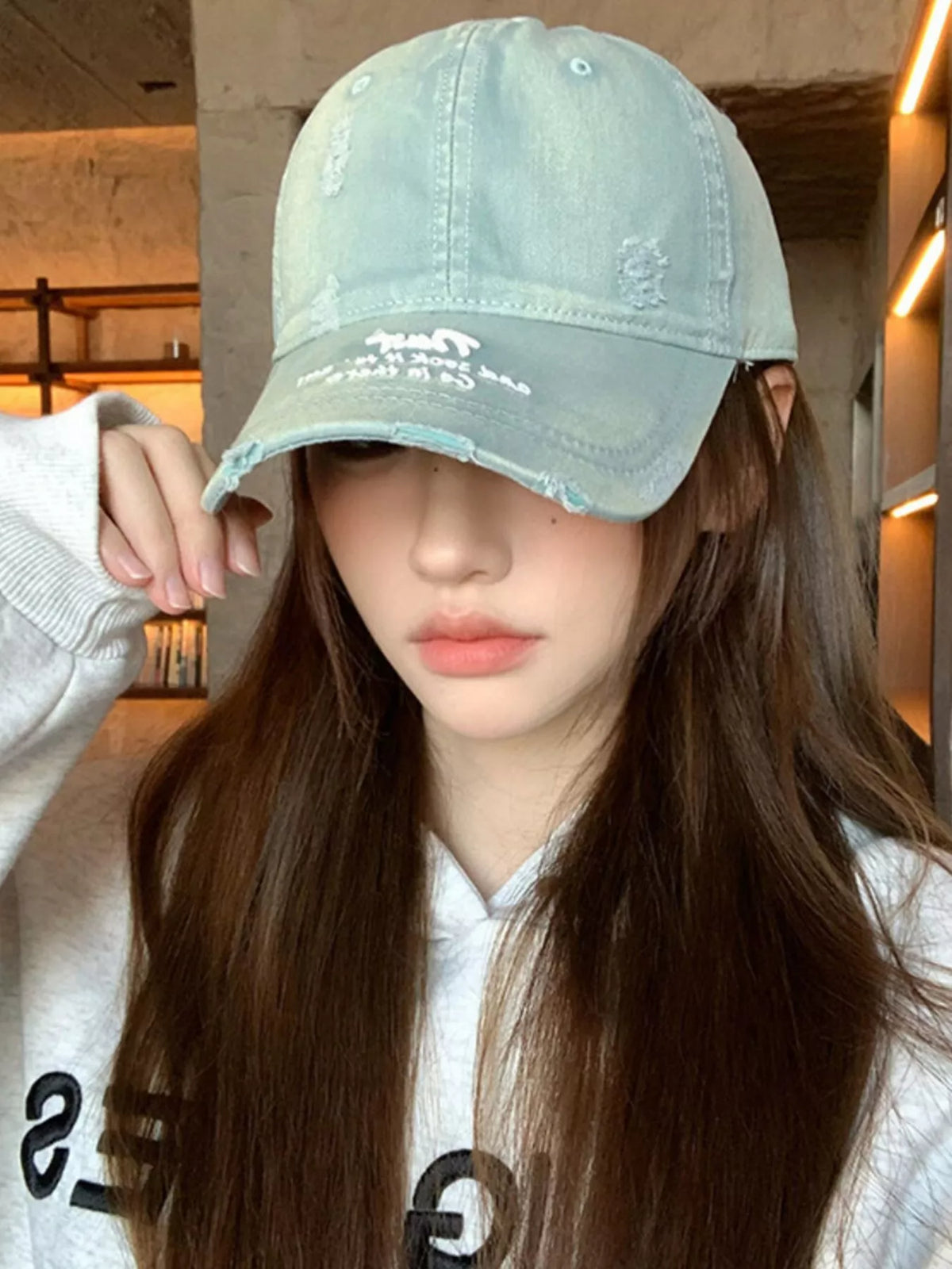 Distressed cap shown in a soft dusty blue colourway