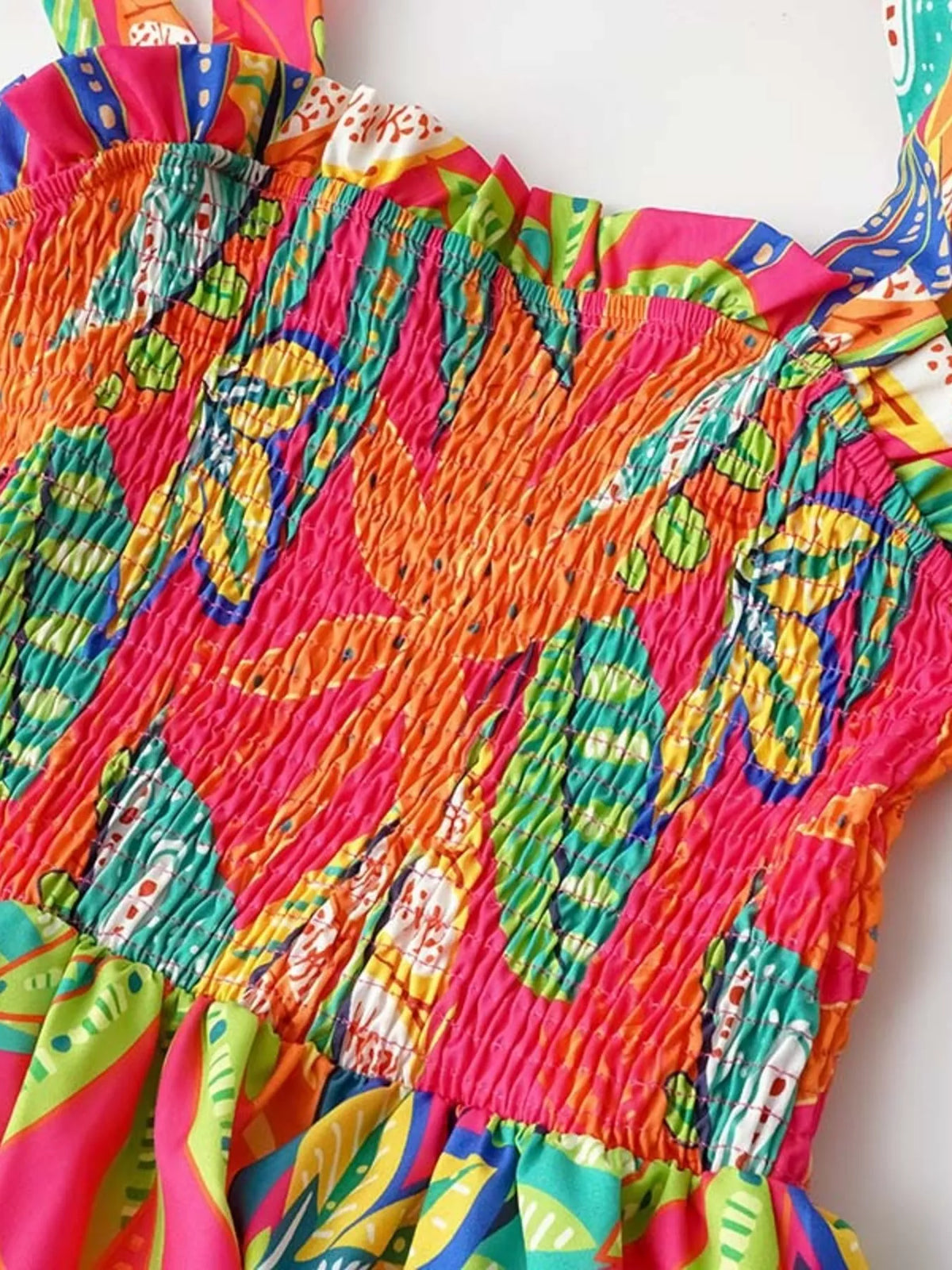 Tropical print smocked tie strap dress detail view