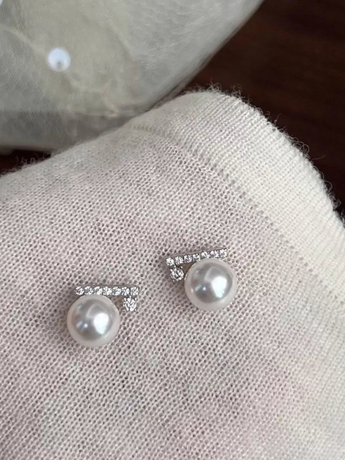 zircon pearl stud earrings flat lay