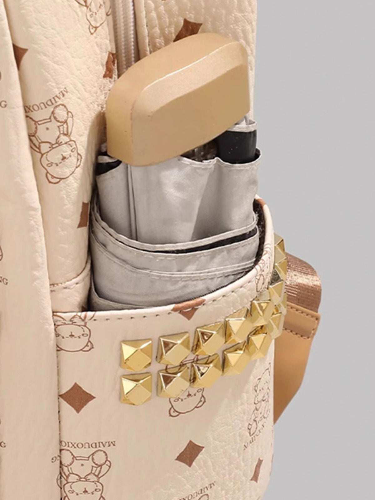 Cream bear mini backpack shoulder strap detail