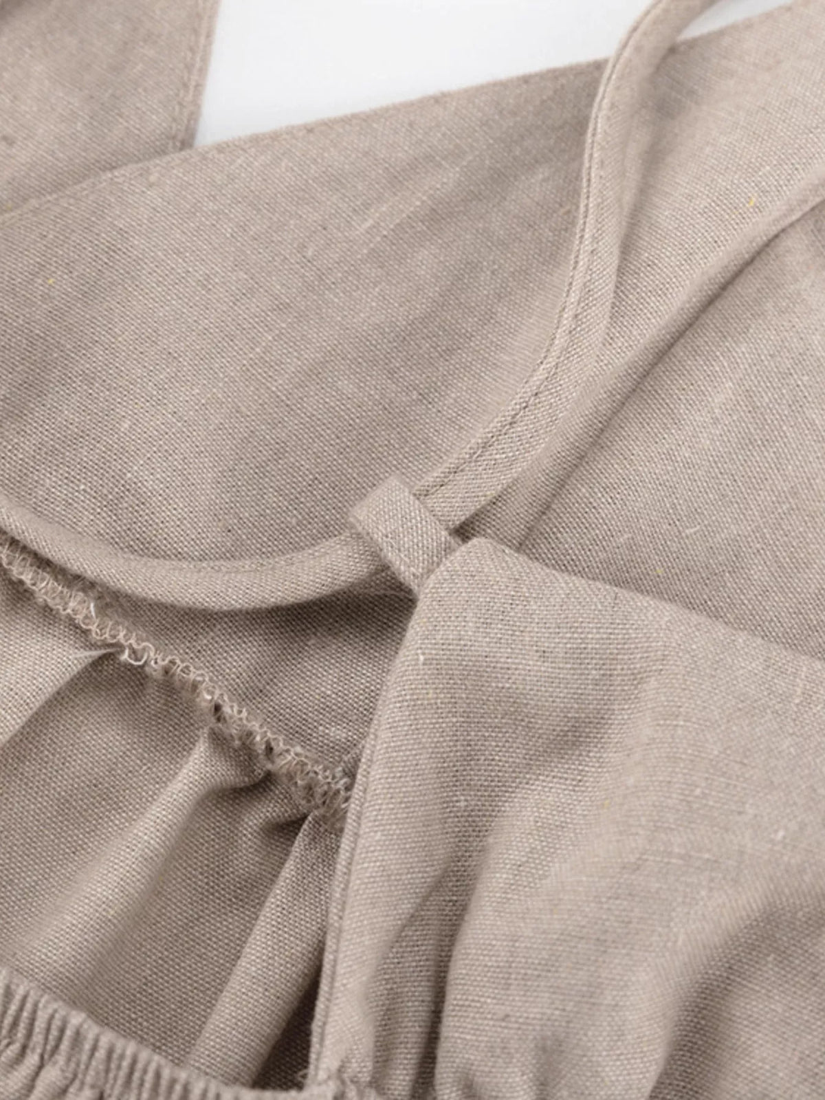 Khaki mini dress shown from the shoulder up