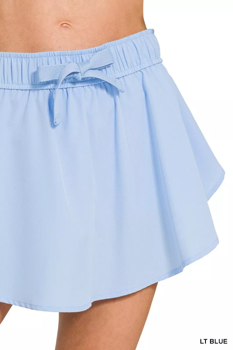Zenana soft woven active skort with pockets in light blue angled view