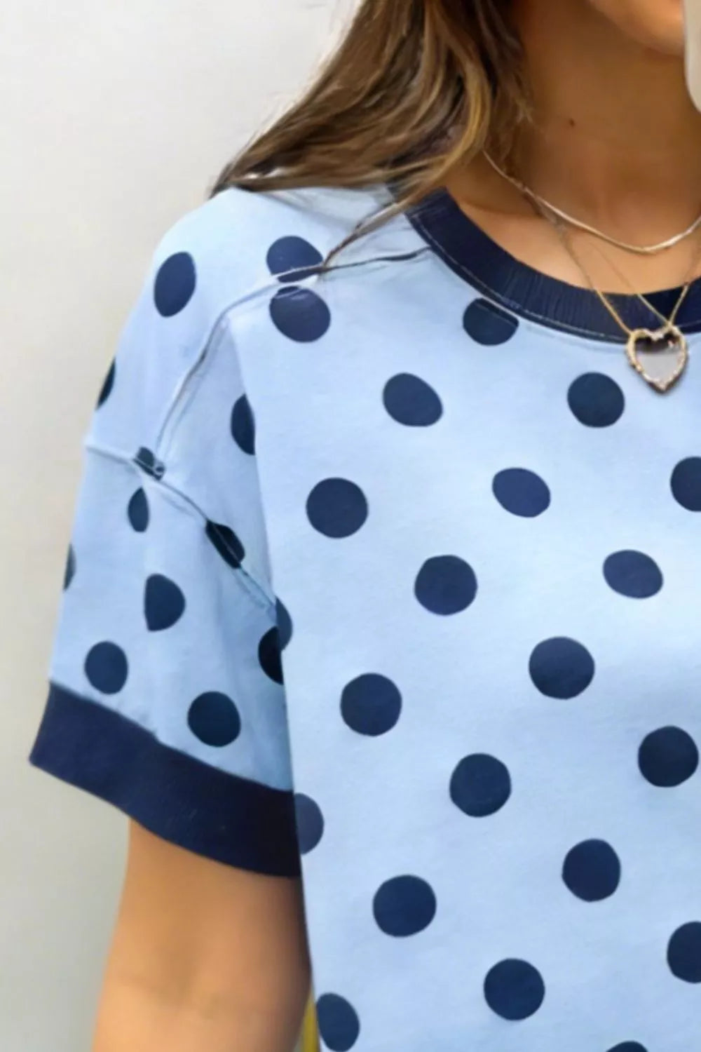 Polka dot pattern detail on blue sweater