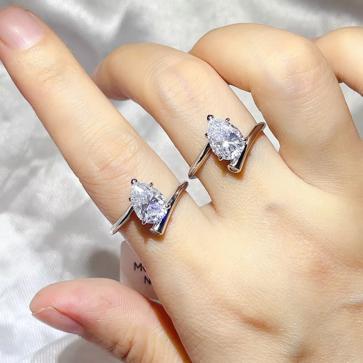 Solitaire ring worn on a hand to show scale