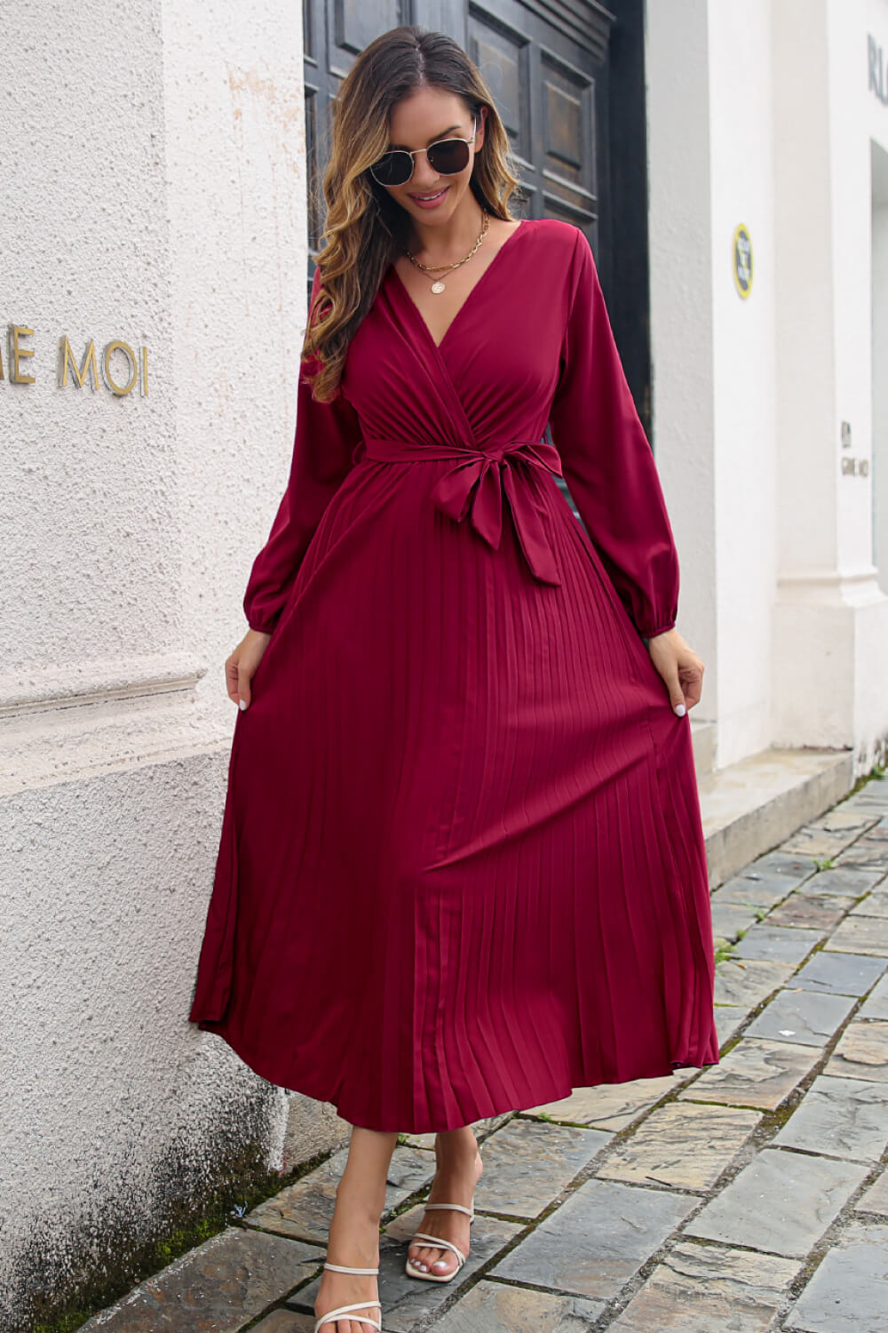 Pleated long sleeve surplice maxi dress hem detail