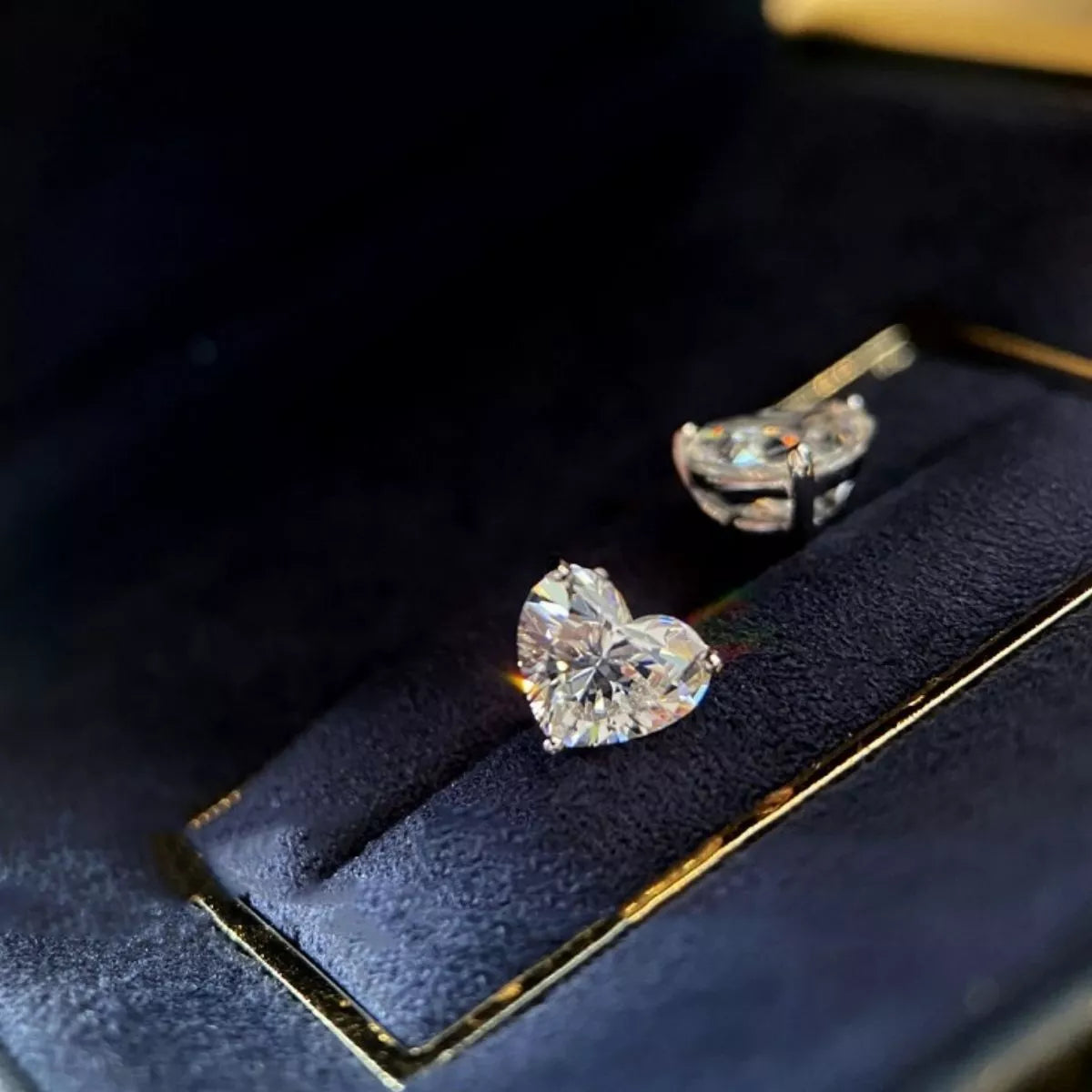 Heart moissanite earring shown worn on the ear