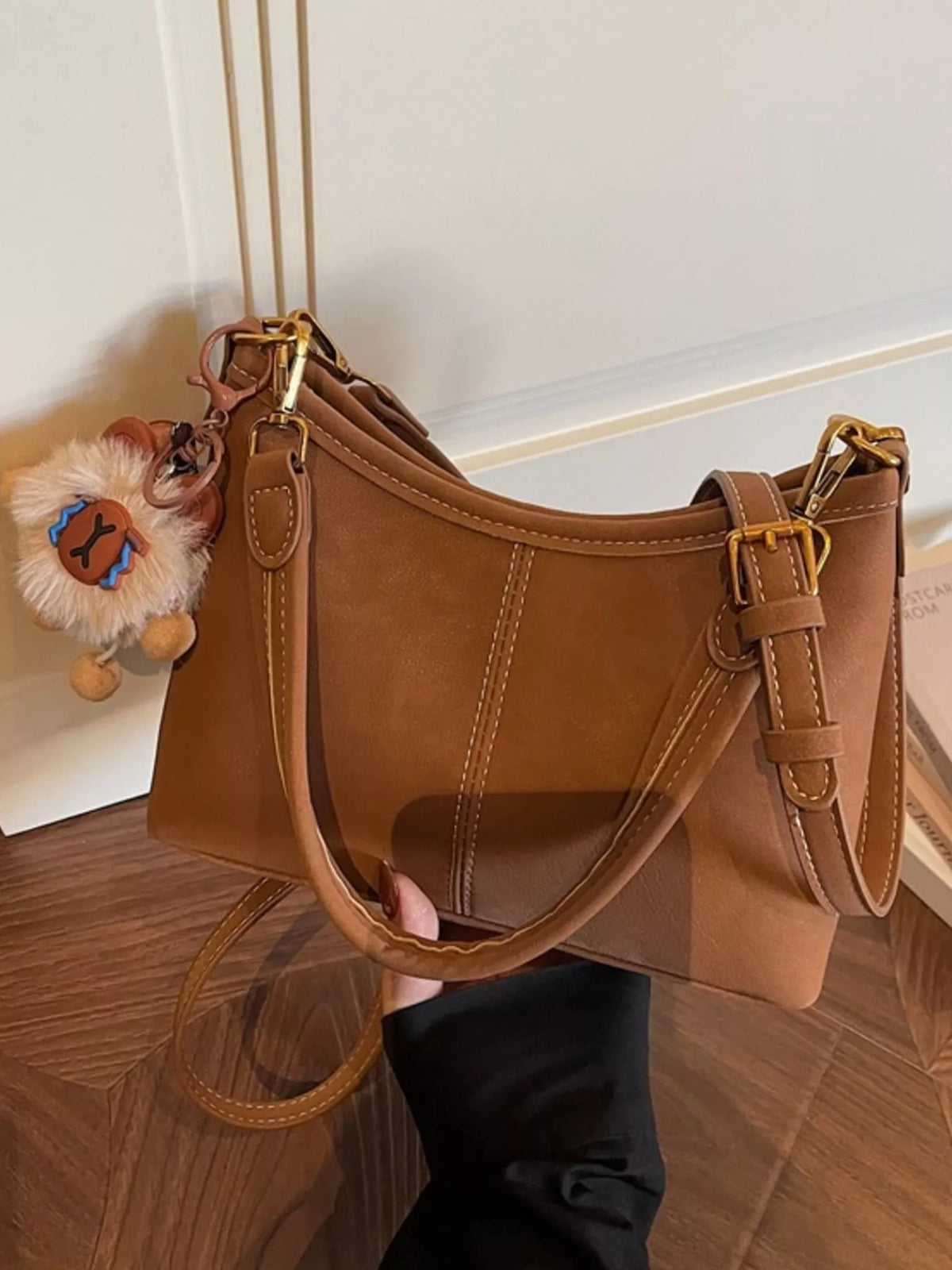 Caramel shoulder bag shown from the side