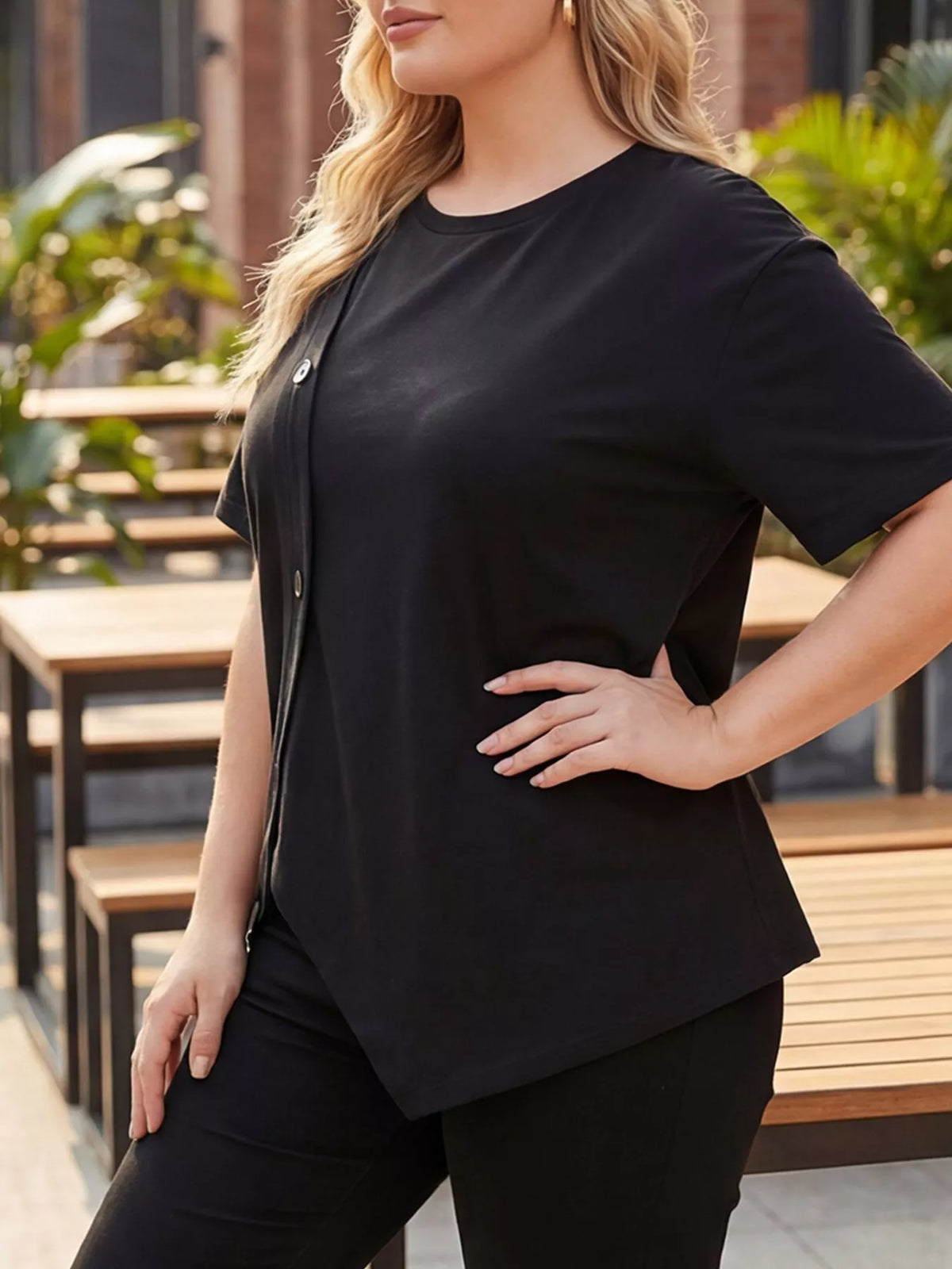 Black short sleeve t-shirt button detail close up