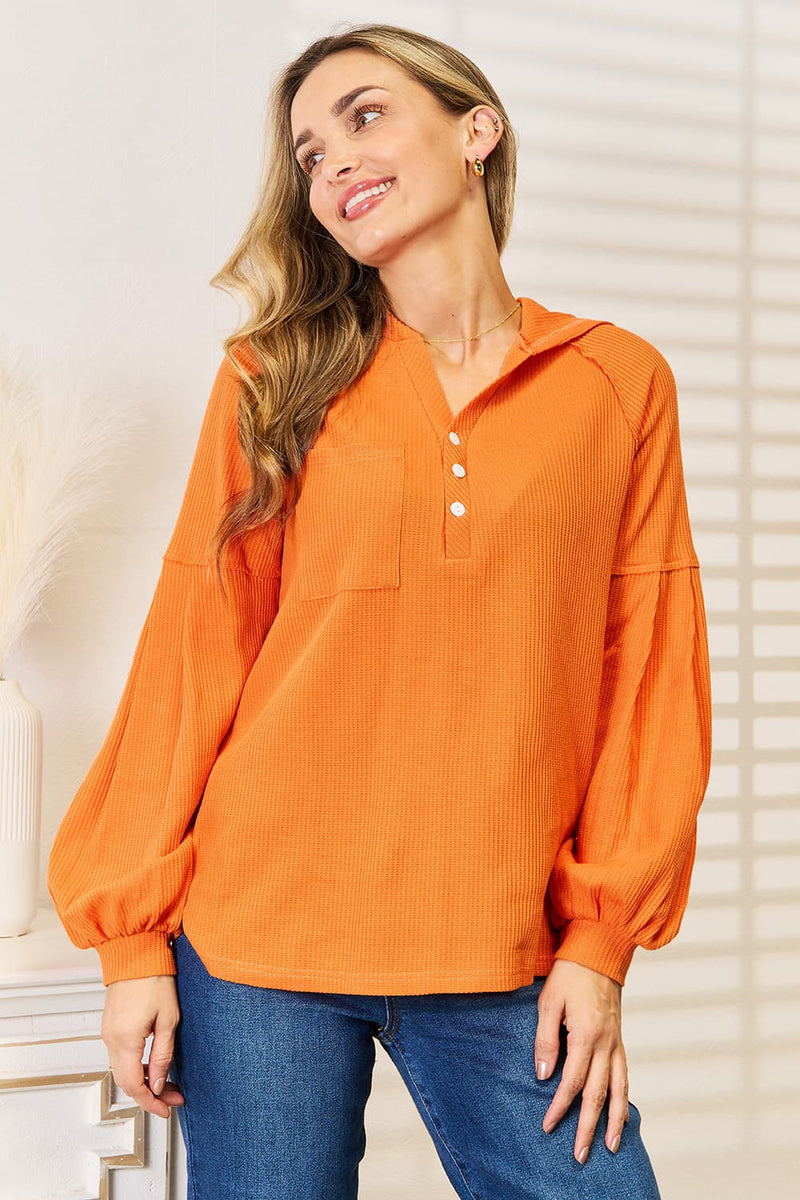 Orange waffle knit hoodie front view on model