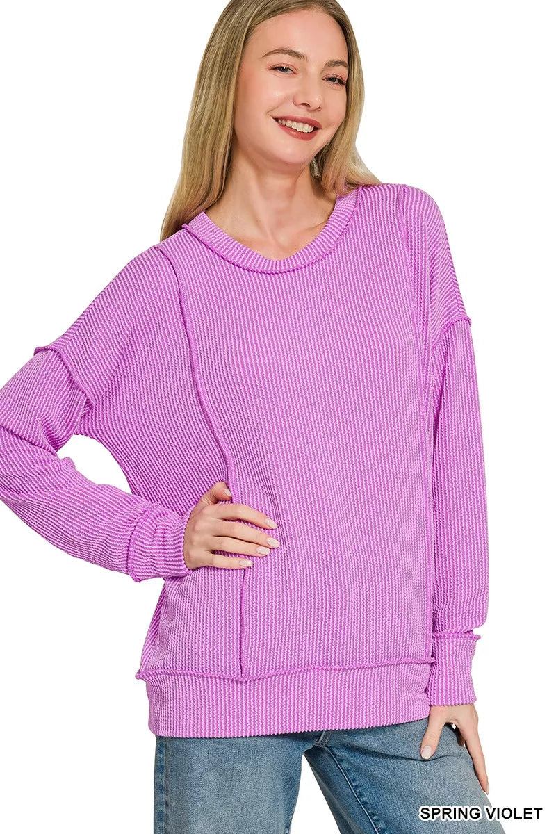 Round crew neckline and exposed seam detail on the rib top