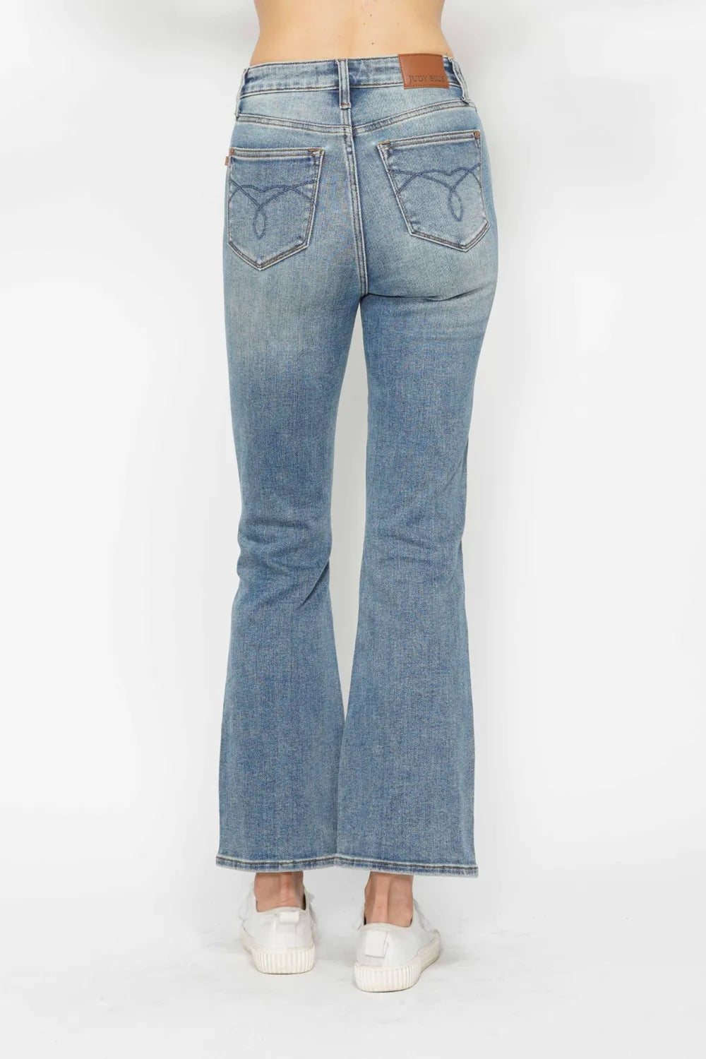 Back view showing the embroidered pocket detail on the jeans