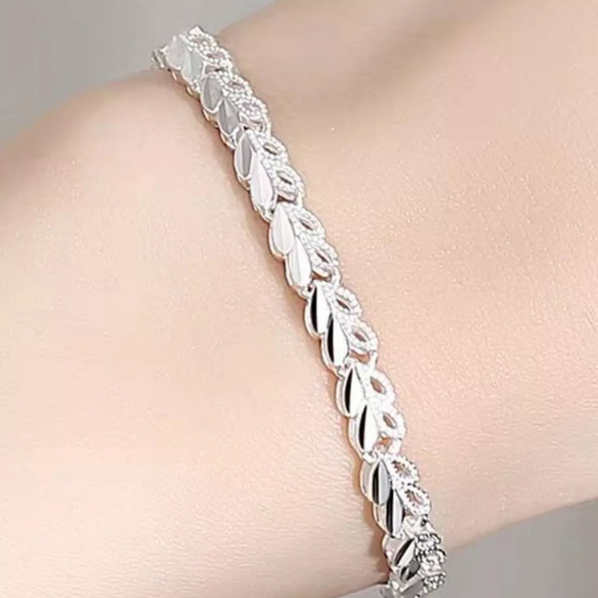 Sterling silver heart bracelet worn on the wrist