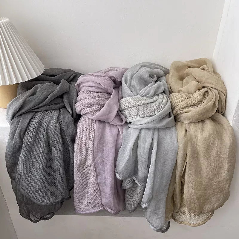 Knitted scarf with softly dyed edges draped at the neck