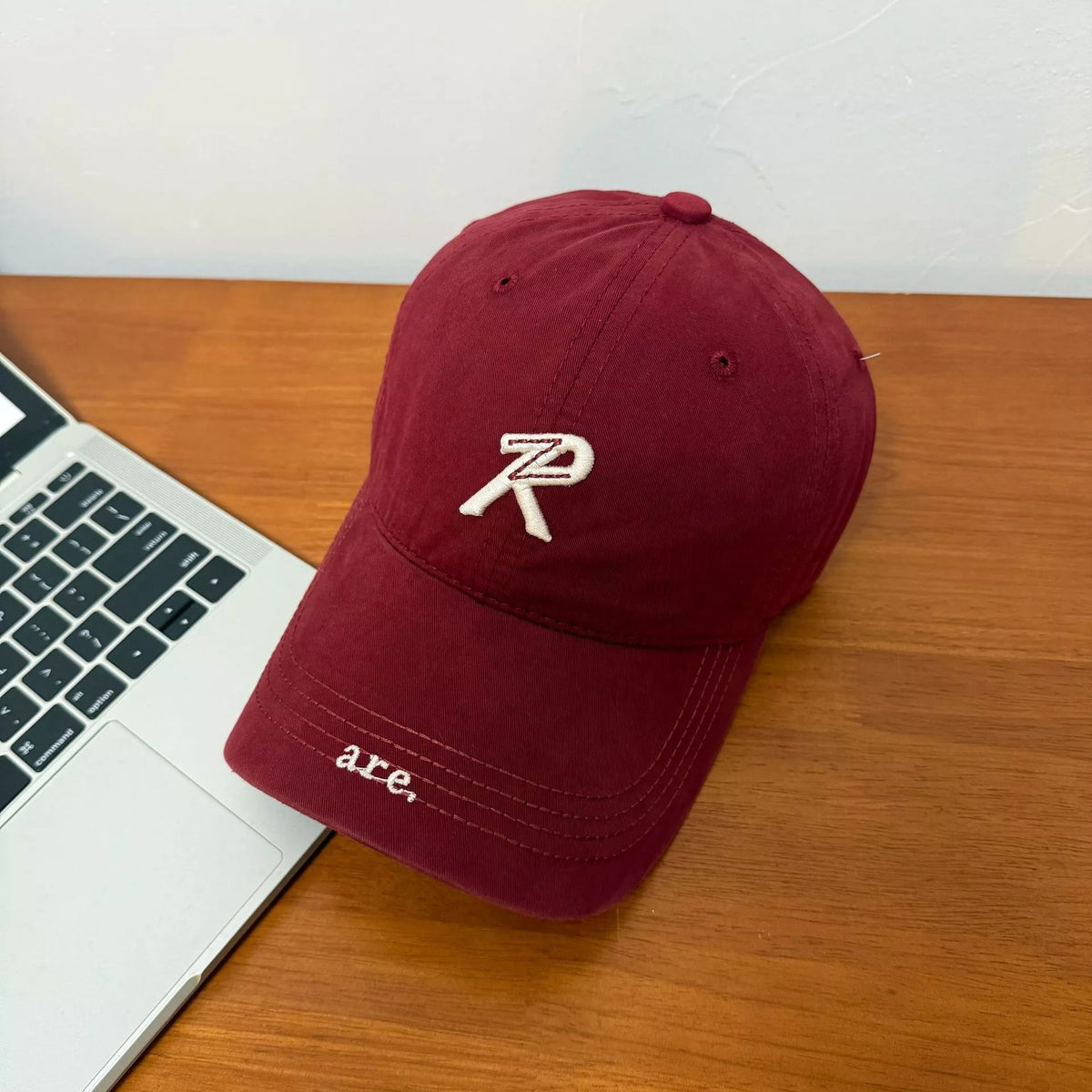 Letter embroidered baseball cap in wine red, front view