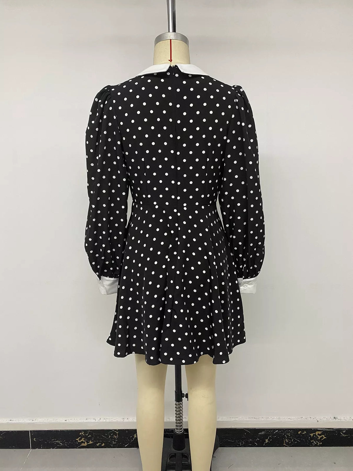 Waist and skirt detail on the black polka dot dress