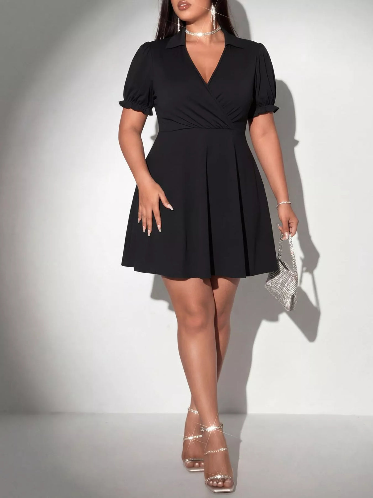 Black surplice mini dress showing ruched detail