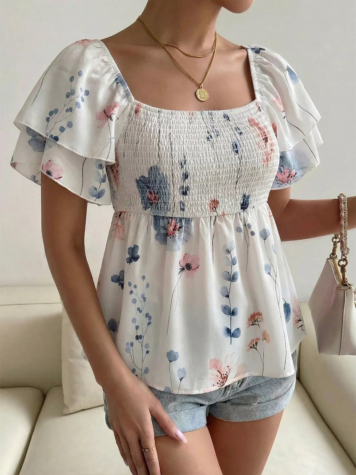 Smocked blouse shown from the side showing the flutter sleeve