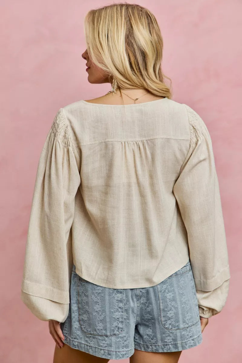Cream linen blend smocked long sleeve top, close up