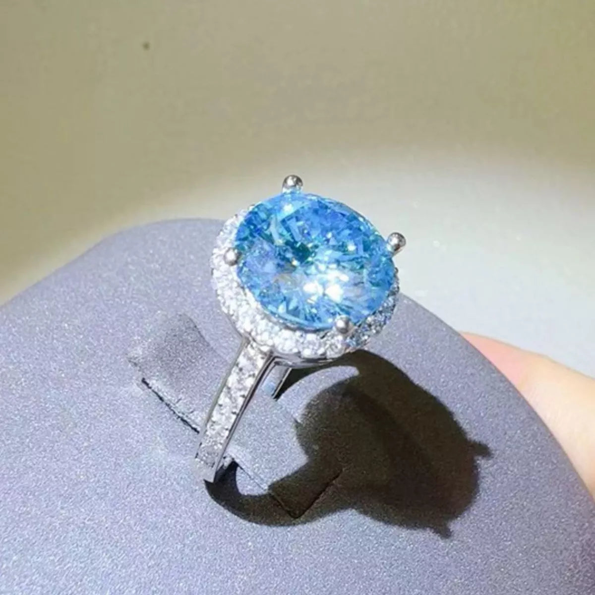 Close up of the sky blue moissanite stone and silver setting