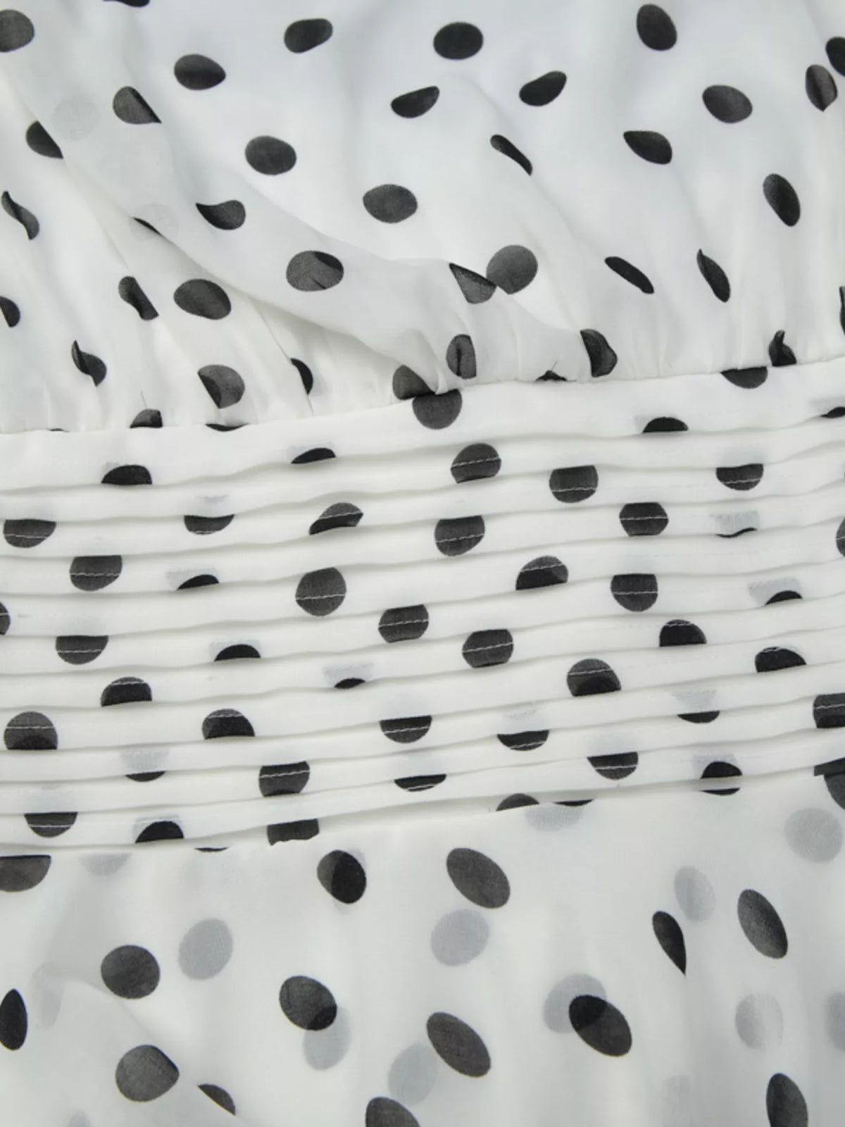 Fabric texture detail of the polka dot dress