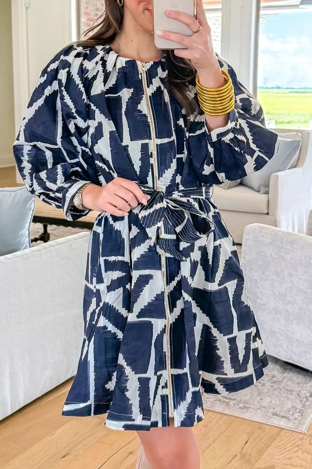 Geometric print shift dress in navy shown from the side with the waist belt tied