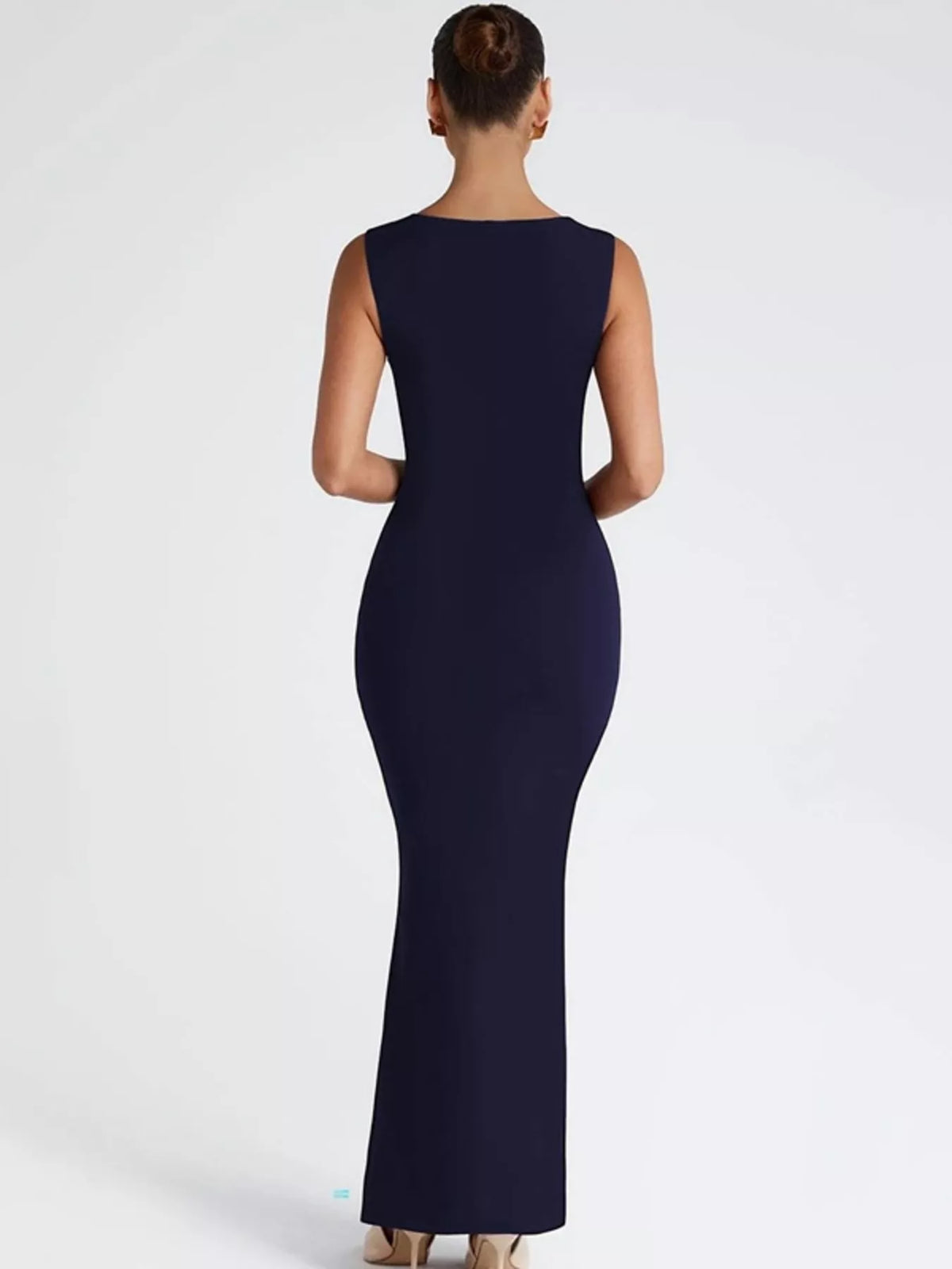 Sleeveless maxi dress worn with a layered necklace