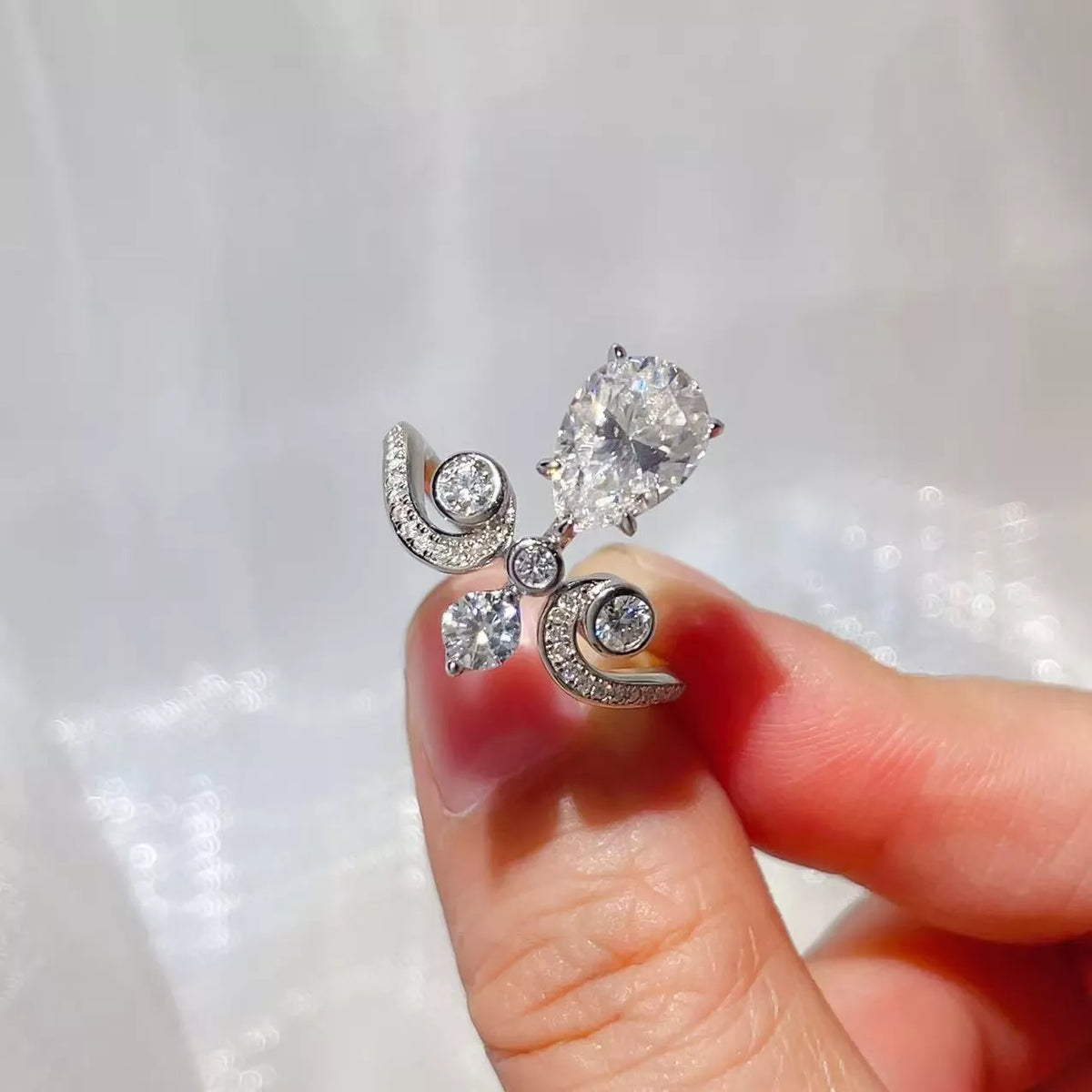 Moissanite ring worn on hand showing scale