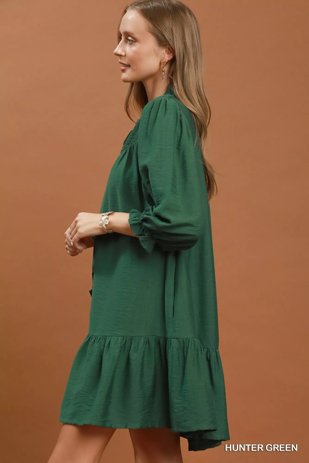 Front view of the green smocked tiered mini dress