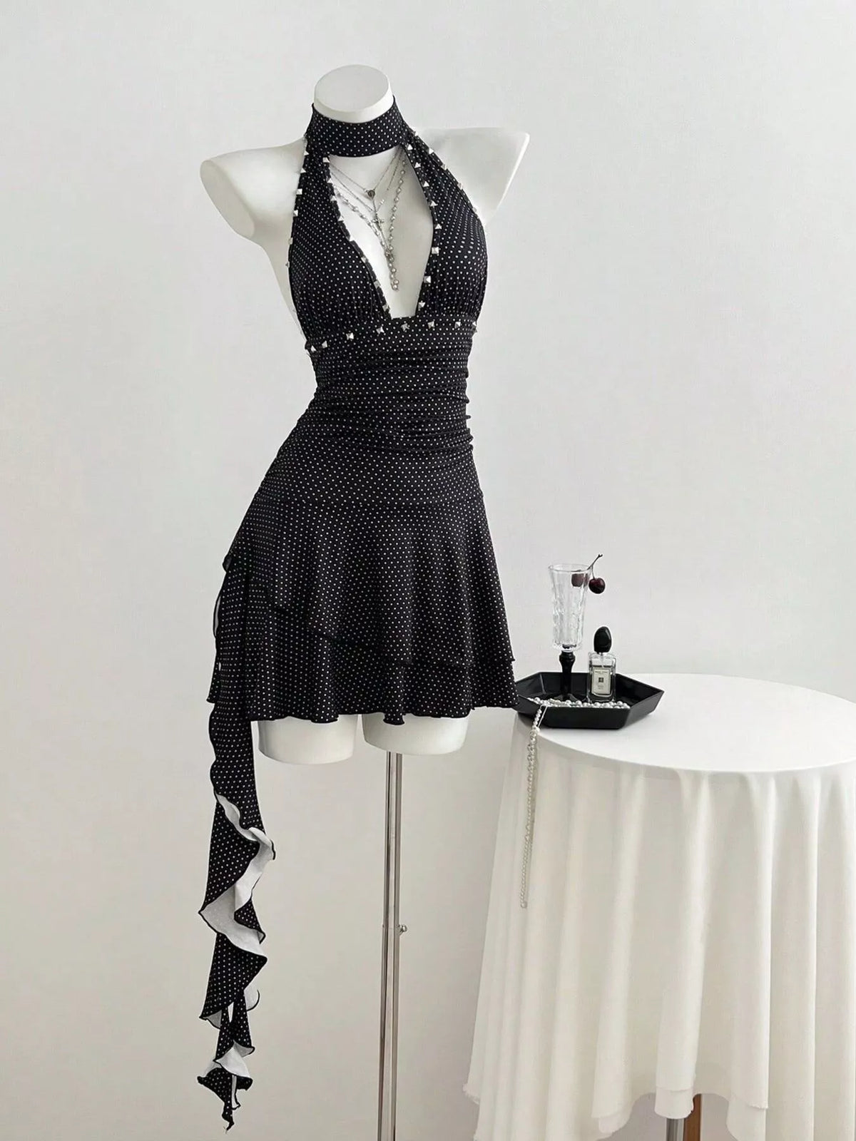 Black polka dot halter neck dress side view