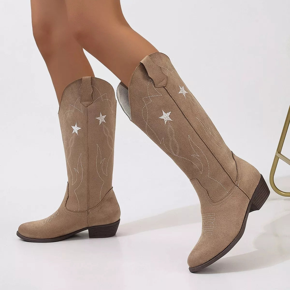Western star embroidered cowboy boots styled on model