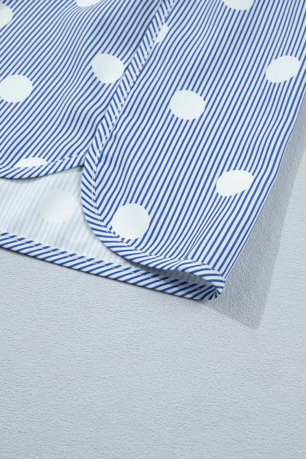 Light blue polka dot elastic waist shorts, angled view