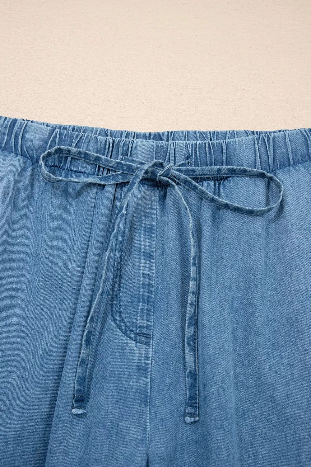 Ruffled hem wide leg chambray pants seated pose